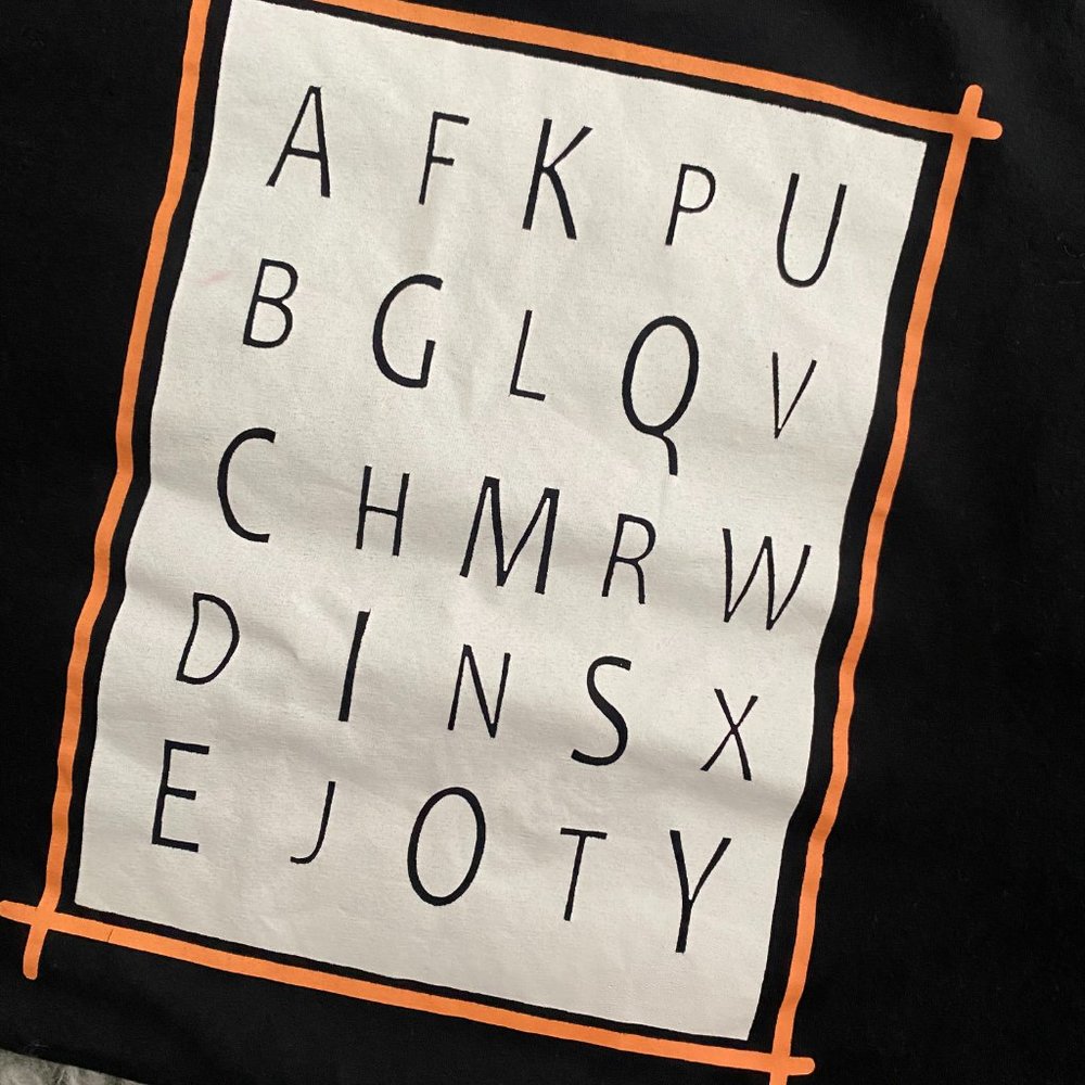 Black and orange letters T-shirt